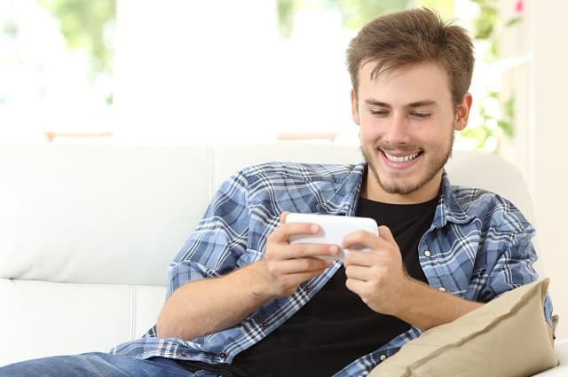 Man playing games for money on a smartphone