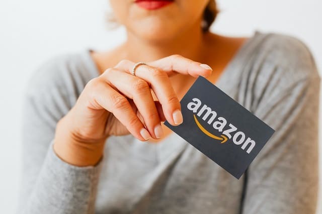 Woman holding Amazon Gift Card