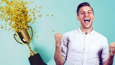 Man celebrating trophy prize confetti win first competition