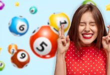 Woman crossed fingers hope luck smile lottery balls draw
