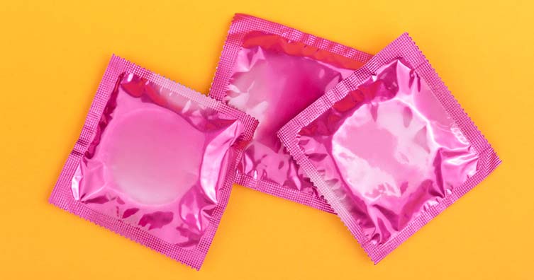 pink condoms yellow background